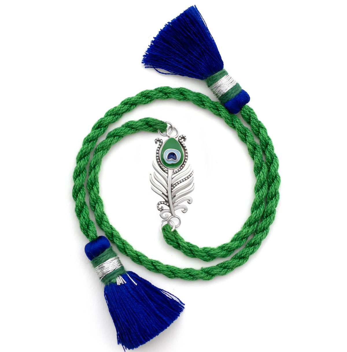 Silver peacock feather charm on a green braided rakhi with blue tassels