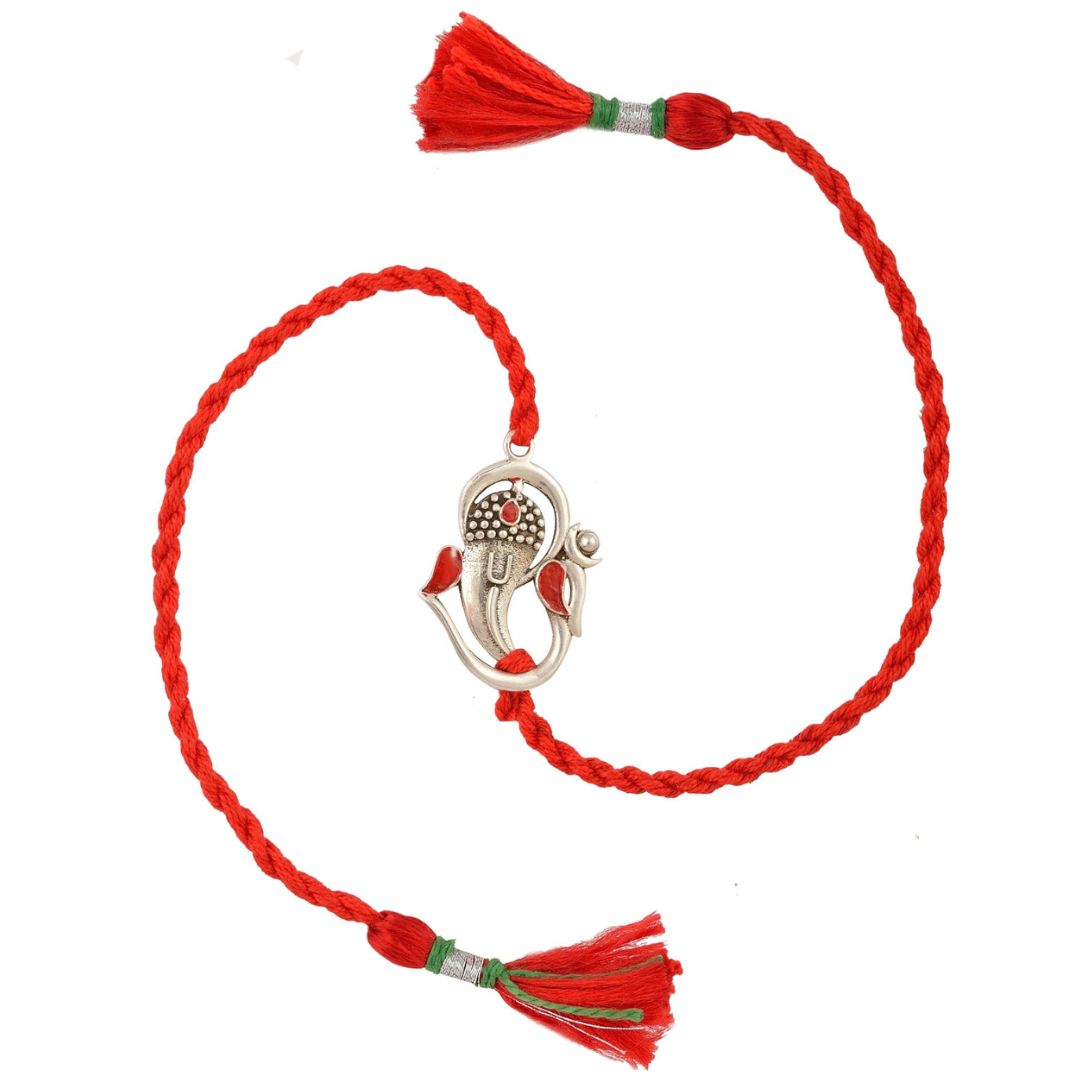 Om Ganesha silver charm on a red braided cotton rakhi with red tassels