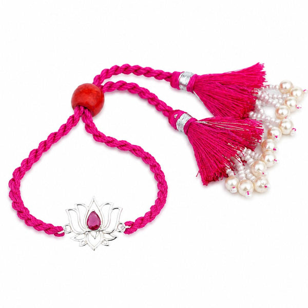 Lotus Bhabhi Lumba Rakhi in silver with a red stone and pearl-drop tassels